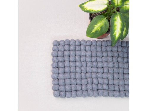 Top view of textured grey wool felt ball cat mat