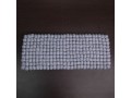 Rectangular grey wool felt ball cat mat on table background