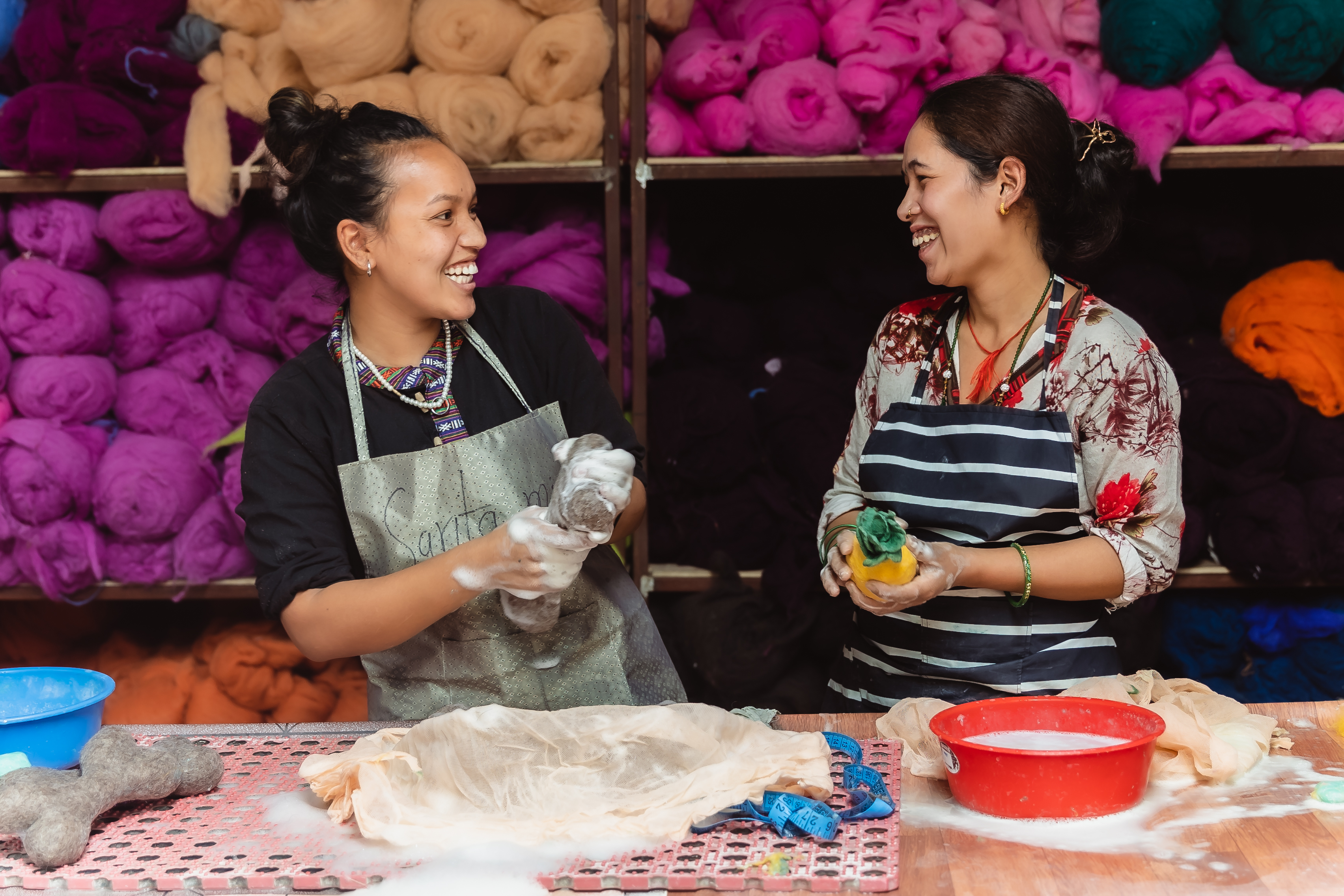 Artisans at Felt and Yarn working together and smiling